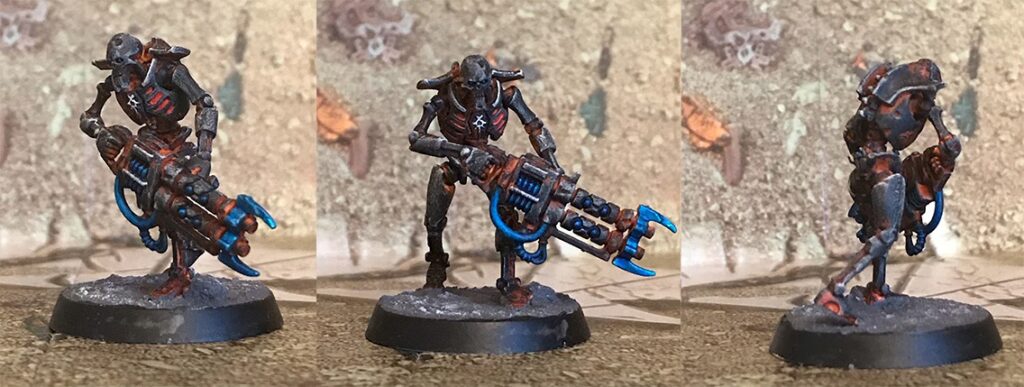 Three photographs of a necron warrior, a skeletal robot painted in a dark, ashy grey, glowing red from inside, with cool blue details on his weapon.