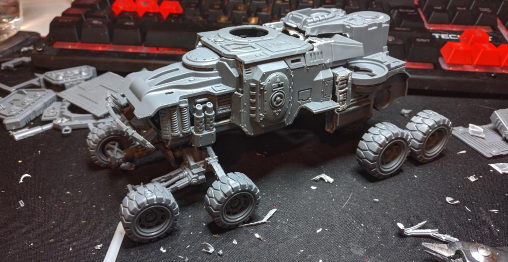 A large unfinsihed vehicle with tiny wheels, assembled from multiple kits.