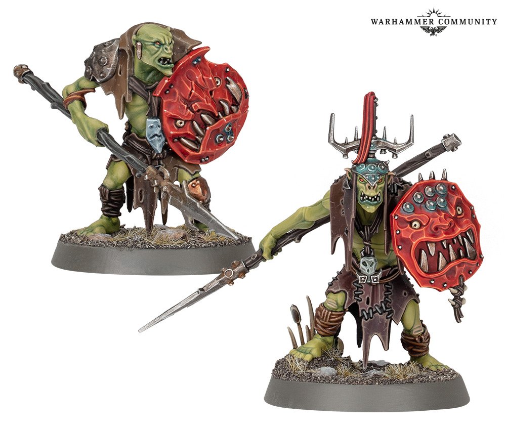 A pair of model orks, armed with vicious spears and shields decorated with leering red faces.