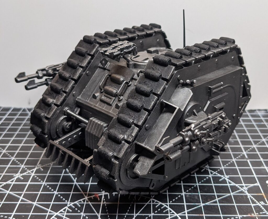 Side view of a vintage Rogue Trader-era Games Workshop Land Raider, Based and drybrushed in a range of silver paints