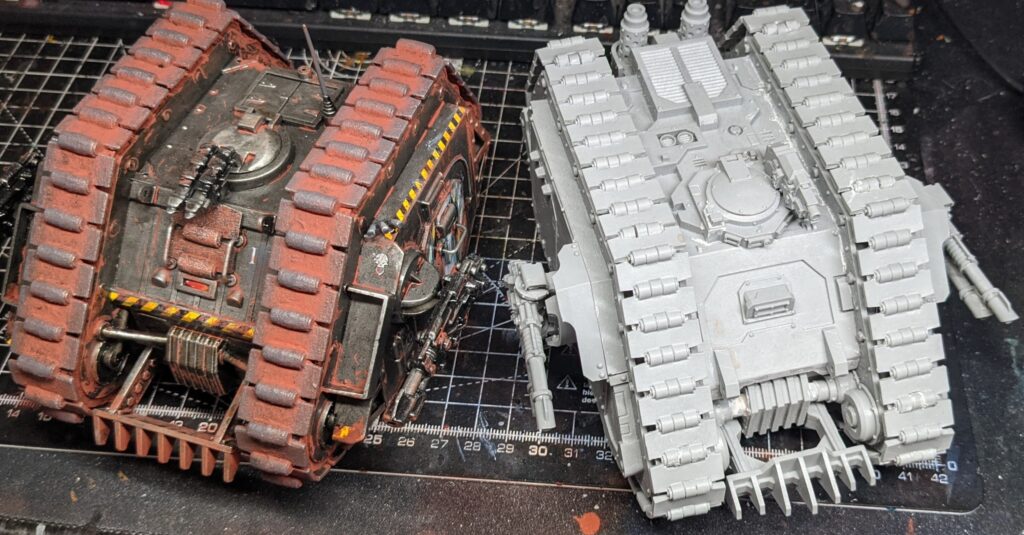 High view of the completed land raider, next to a modern Land Raider Proteus from Forge World.