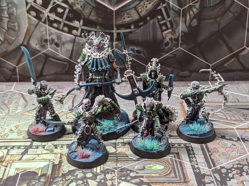 Six armoured skeleton models, painted with grey bone and green armour.