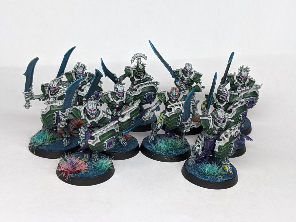 A unit of ten skeletal construct warriors, armed with dark blades and segmented green shields