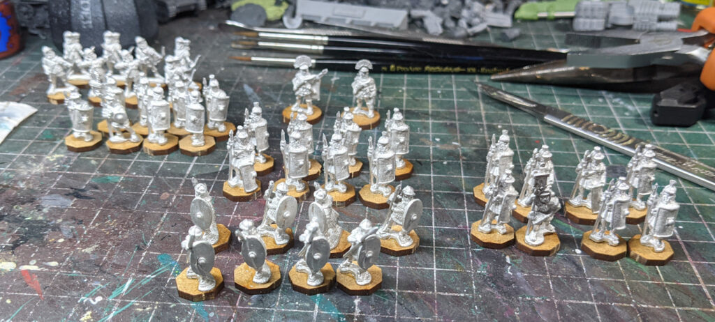 An array of small-scale metal Roman soldiers, on MDF hexagonal bases
