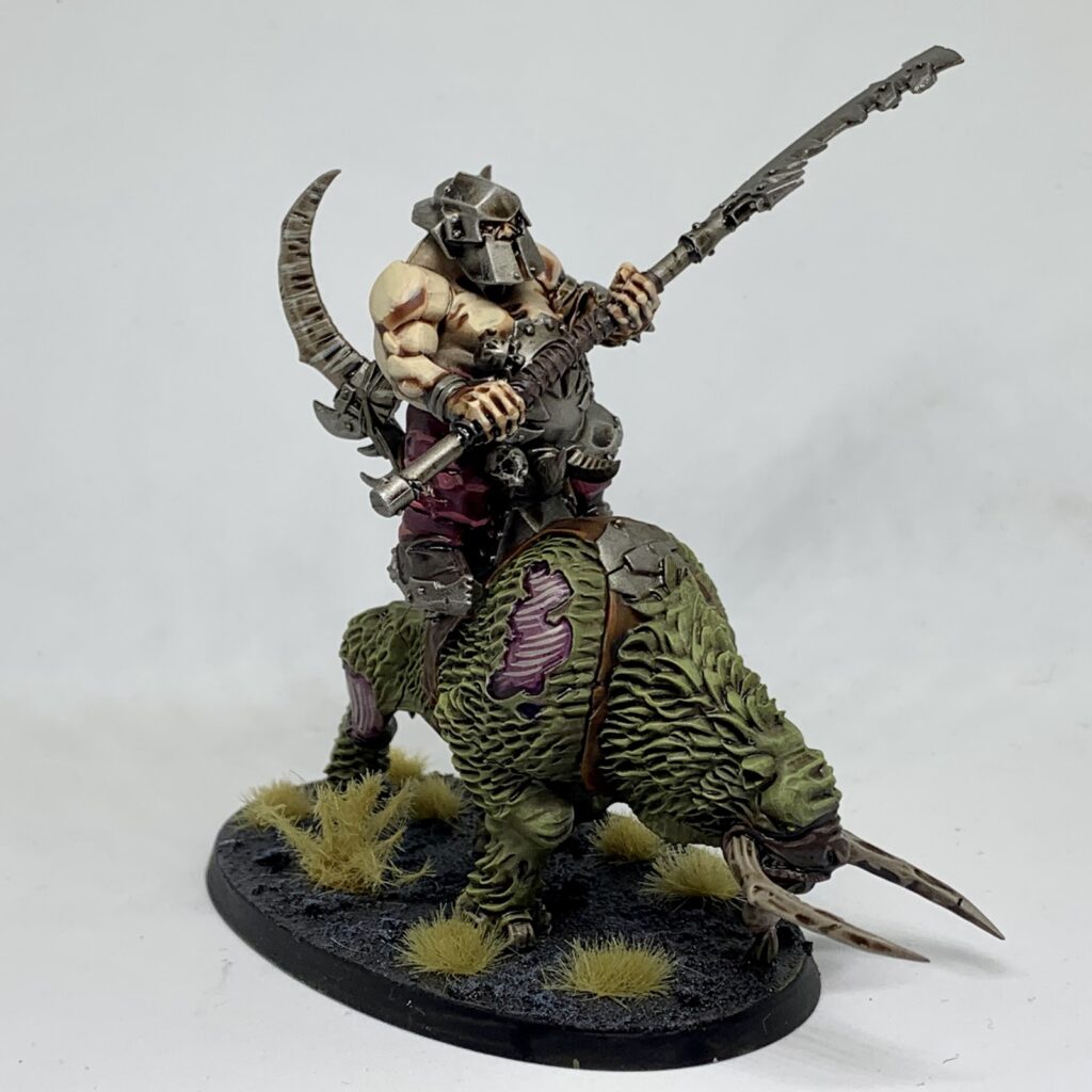 One lone Ogor riding atop a smaller beast, its moss green hide and flayed skin make up its bulk. That and its bone white goring horns.