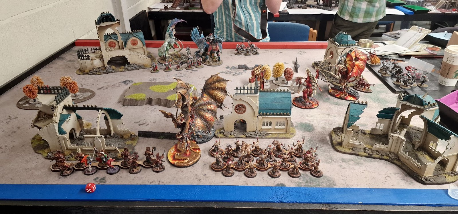 A table laid out for a 2000 point Age of Sigmar battle.  One force has 4 Bloodthirsters, the other is Stormcast Eternals with 2 dragons.